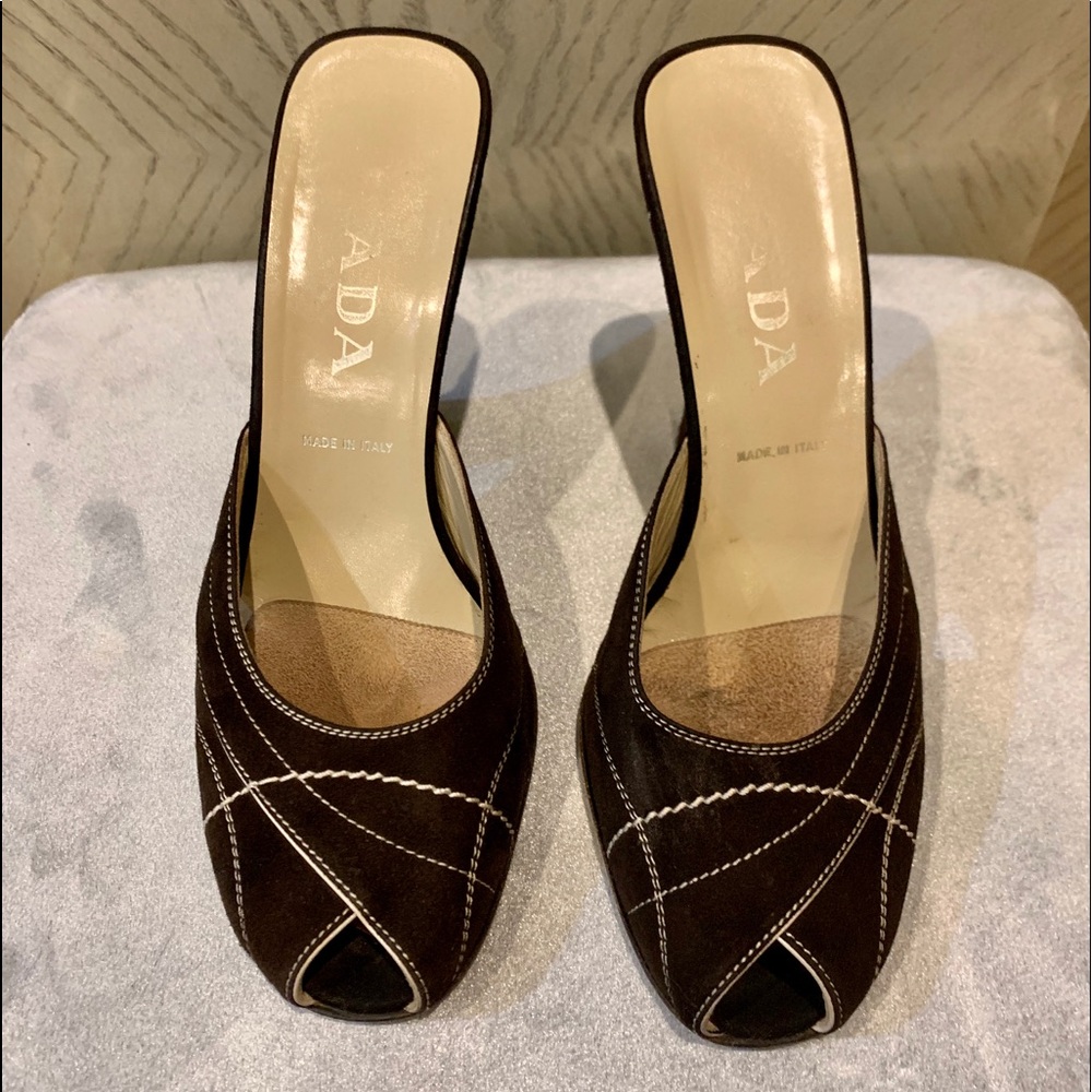 Auth Prada Mules in black leather w/ white piping.